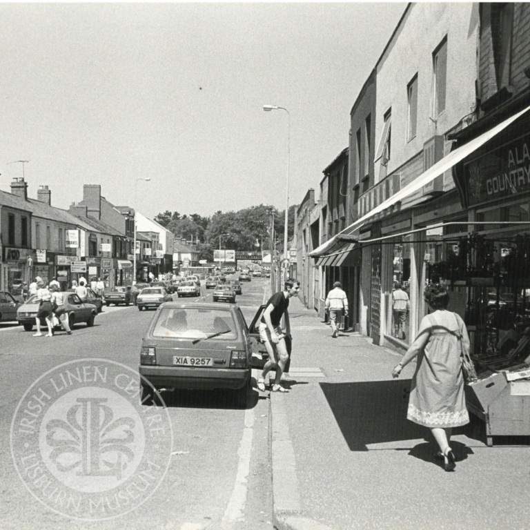 Black and white image from our photographic collection of a busy Antrim Street.